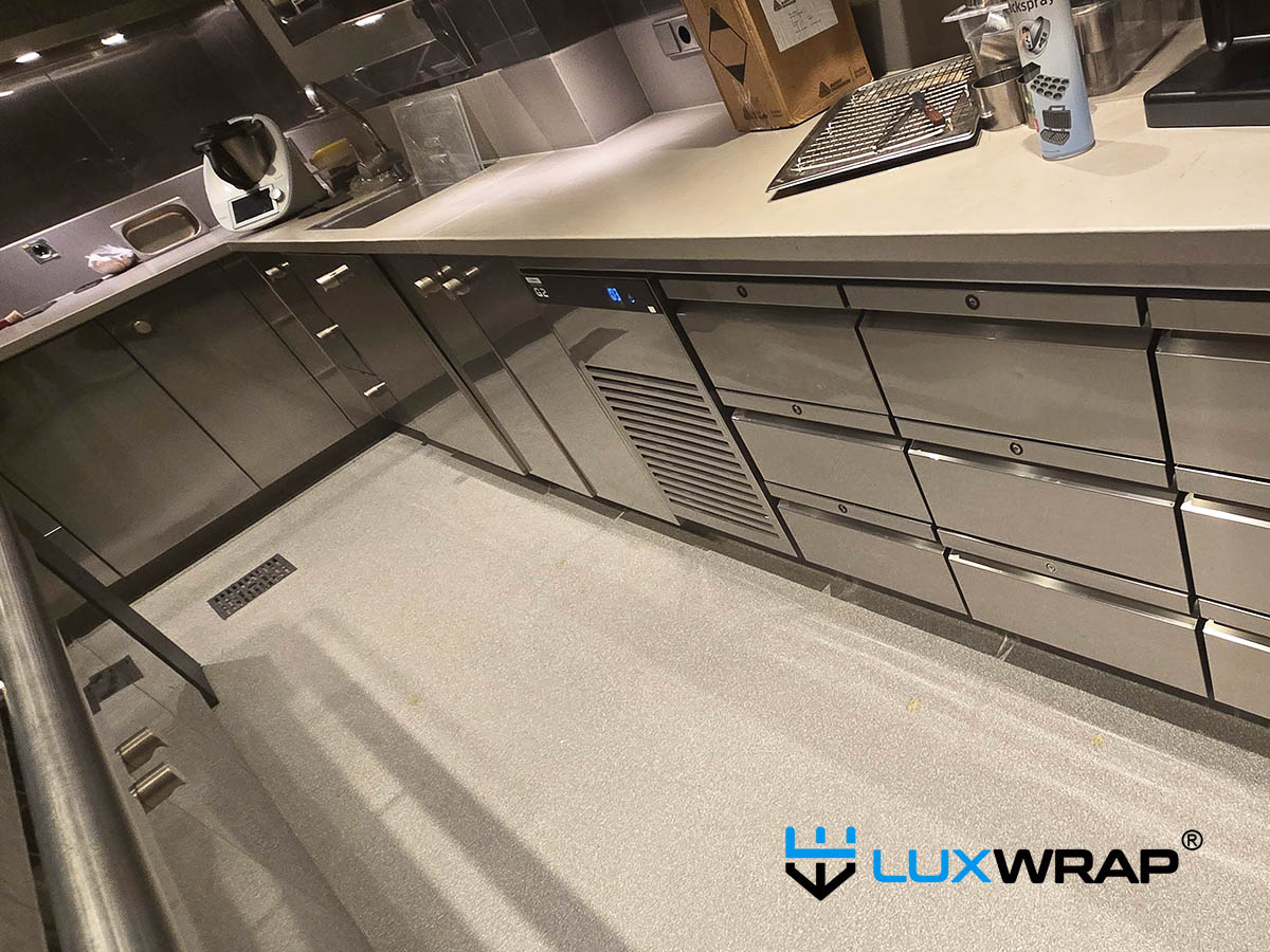 Superyacht galley base units wrapped by LuxWrap in clear gloss PPF.