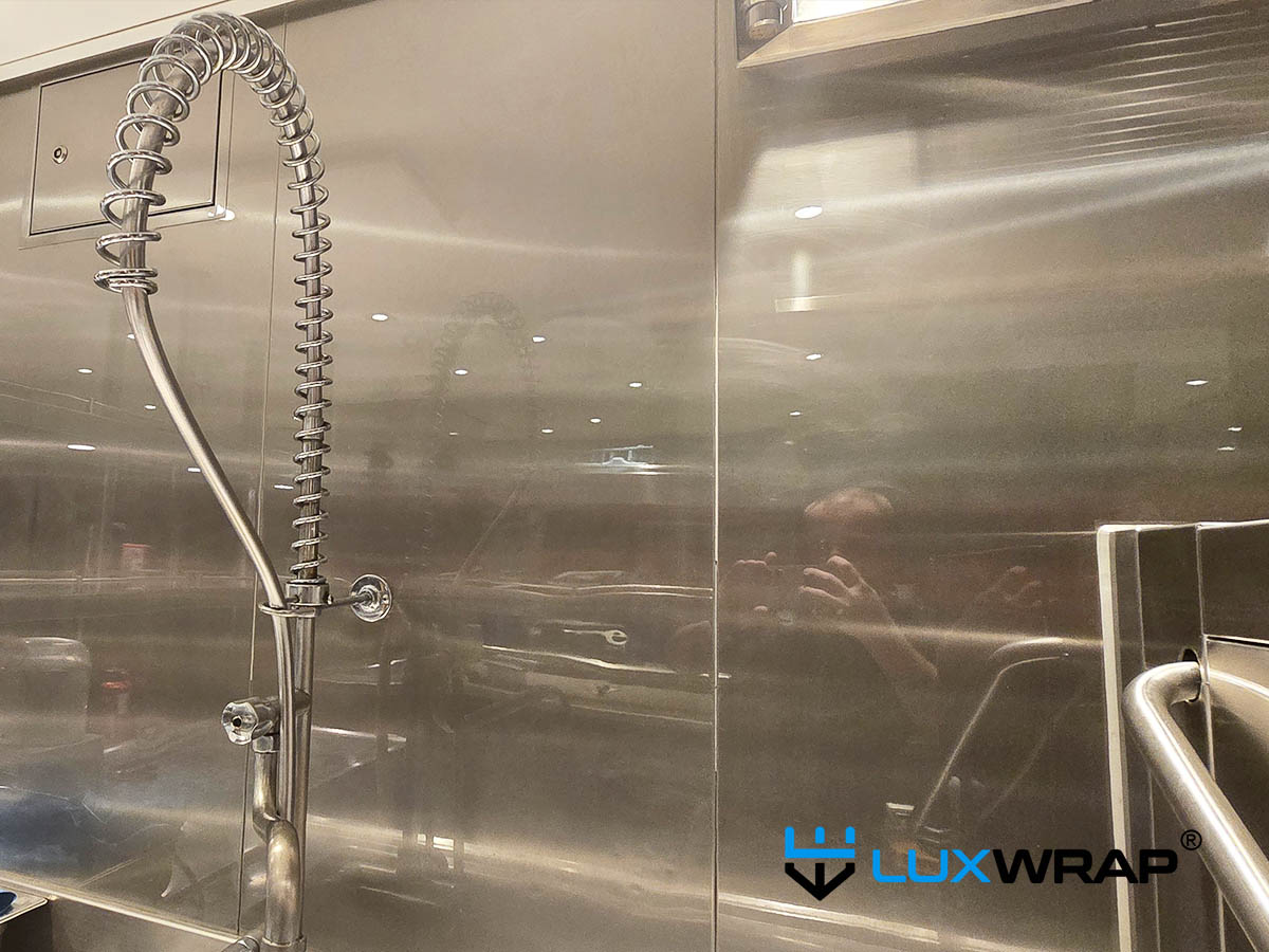 New-build yacht galley dishwasher and walls wrapped high gloss NinjaShield PPF surface and paint protection film