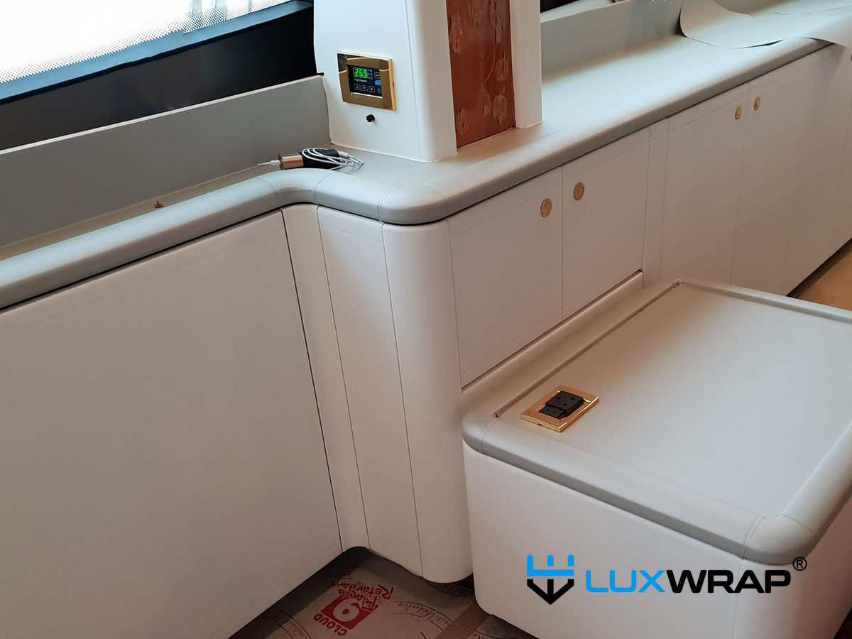 Full yacht interior transformation using leather-effect architectural film — applied to walls, doors, and furniture throughout