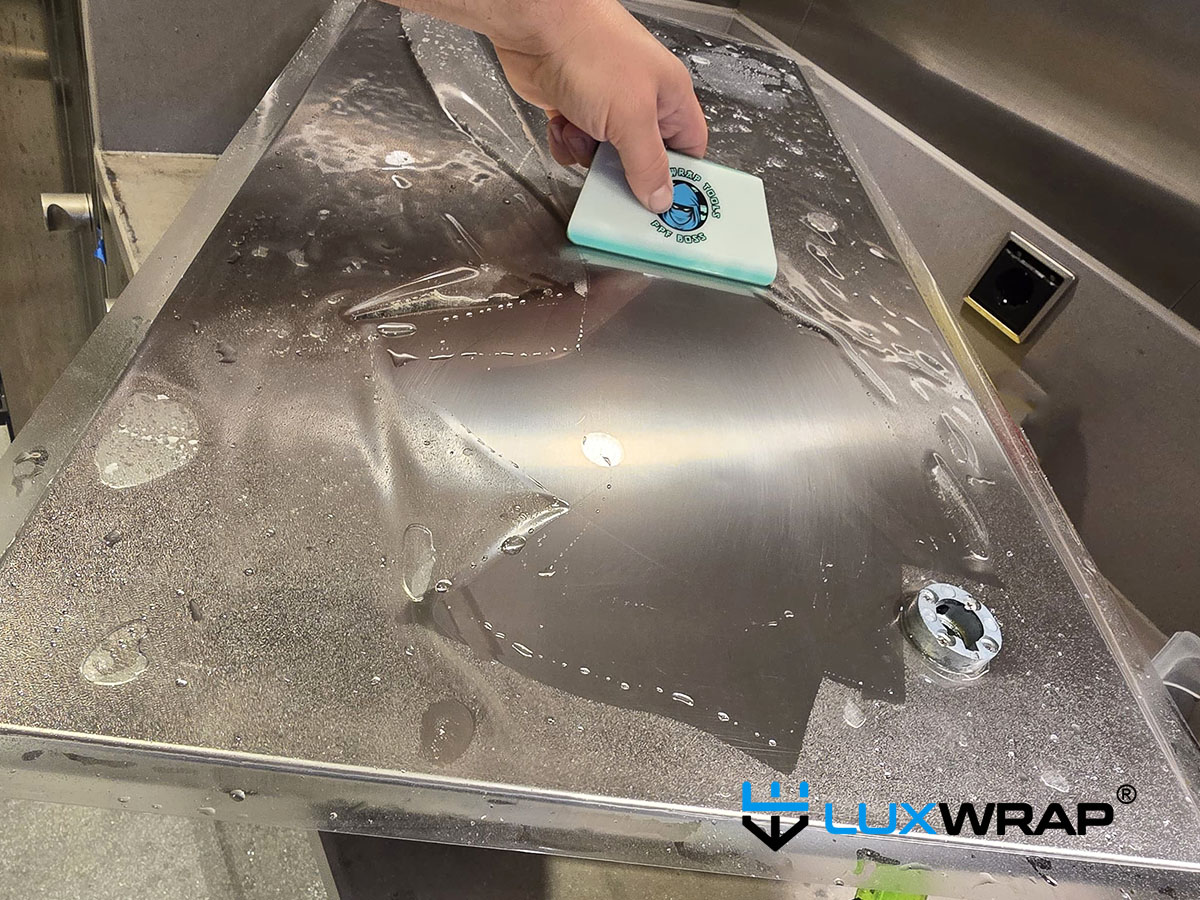 LuxWrap installation of NinjaShield Gloss PPF in superyacht galley.