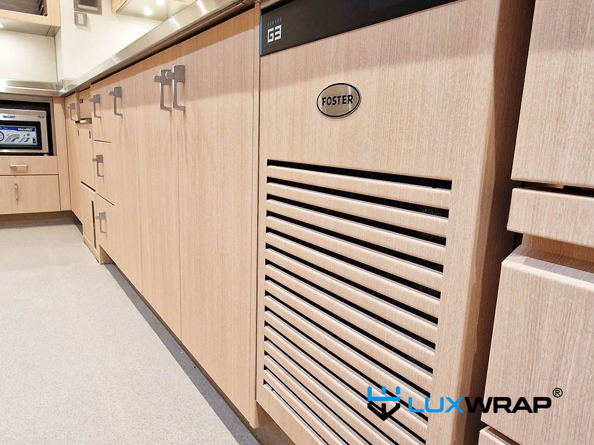 New-build yacht galley transformed from stainless to wood grain, with PPF elements