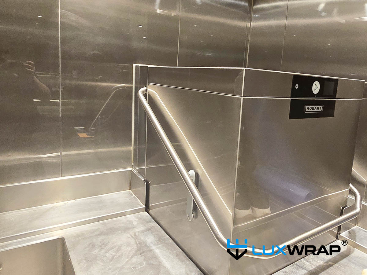 New-build yacht galley dishwasher and walls wrapped high gloss NinjaShield PPF surface and paint protection film