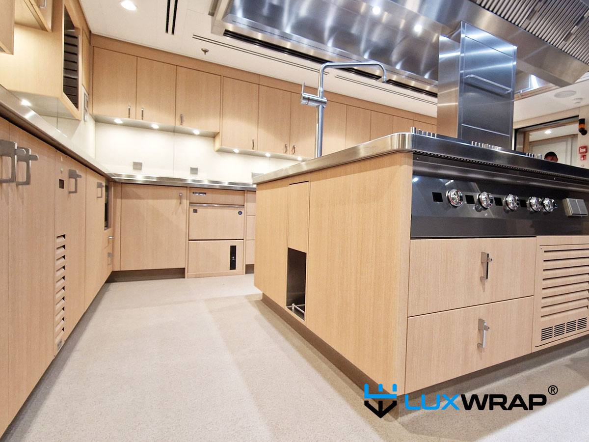 New-build yacht galley transformed from stainless to wood grain, with PPF elements