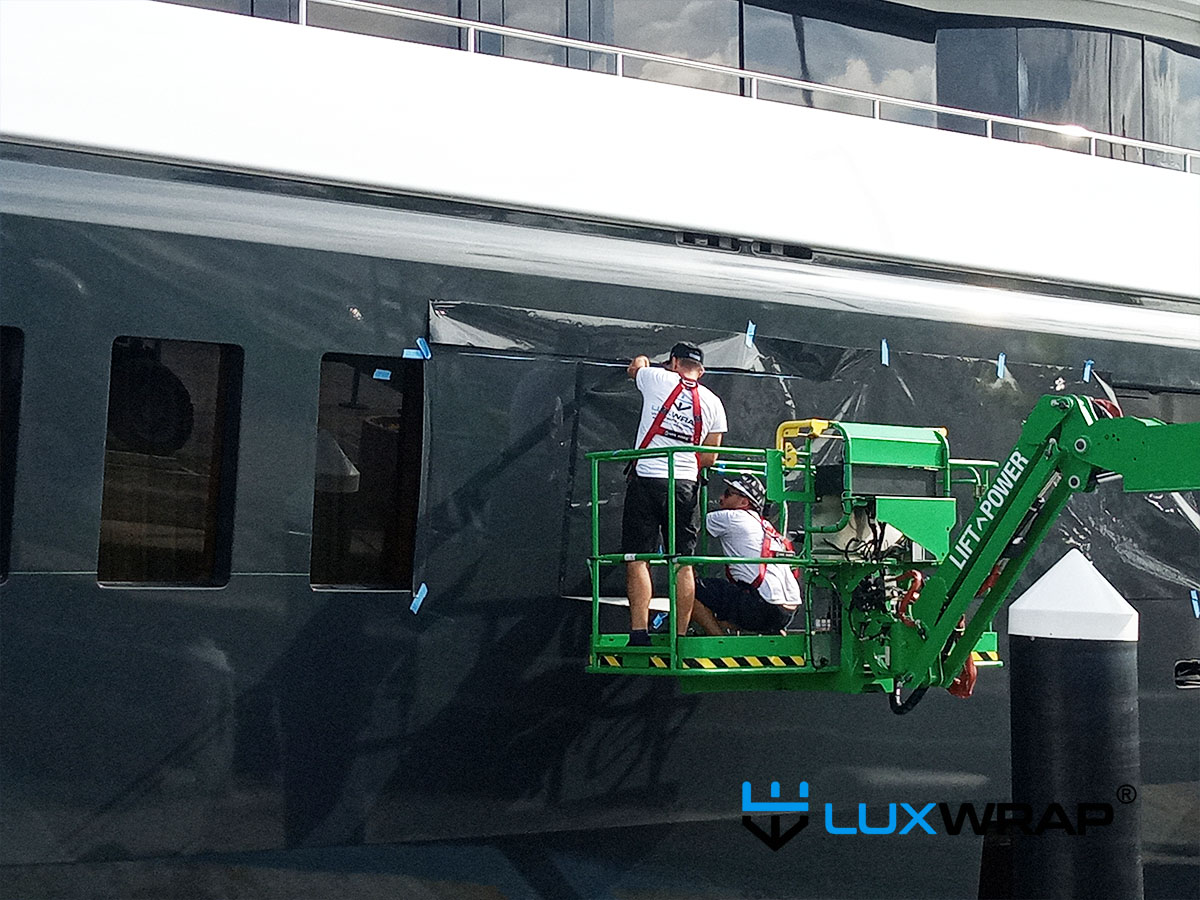 LuxWrap use cherry picker platform to wrap superyacht hull in colour matched vinyl