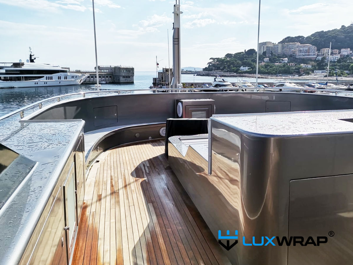 Entire superyacht superstructure wrapped in metallic silver vinyl by LuxWrap — every internal and external surface covered