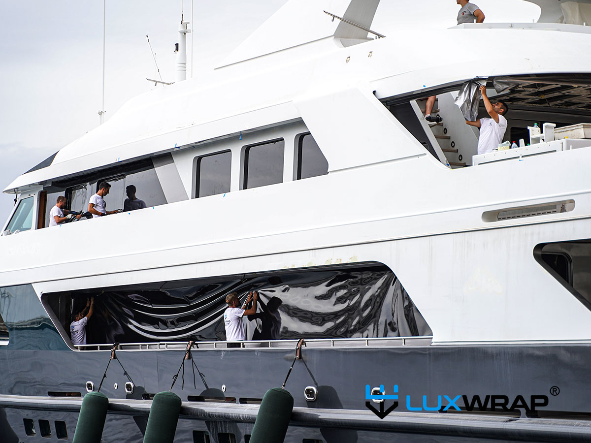 Superyacht accent wrapping — white panels between windows wrapped black to give the appearance of larger windows and modernise vessel lines