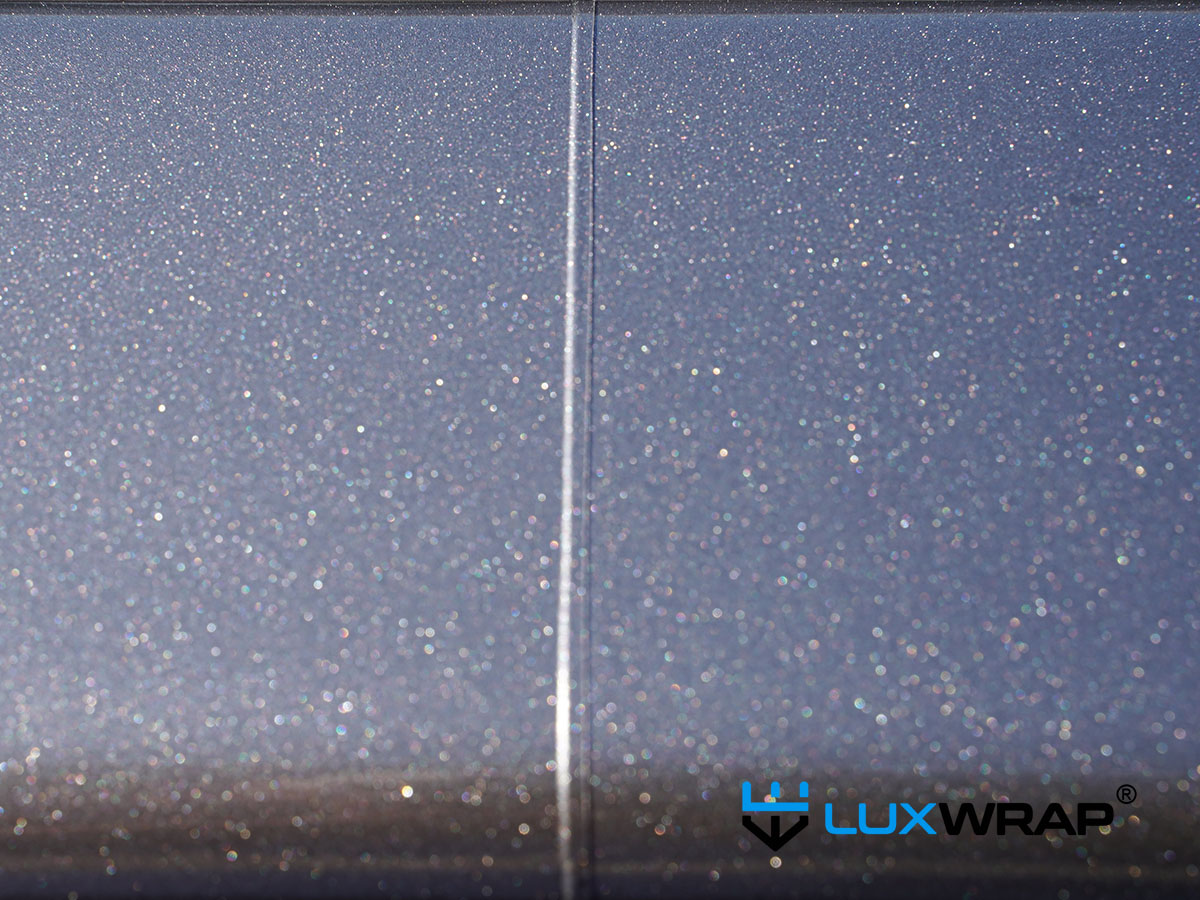 Close-up of a precision vinyl join on a superyacht wrapping project — executed using specialist cutting tape along natural vessel lines