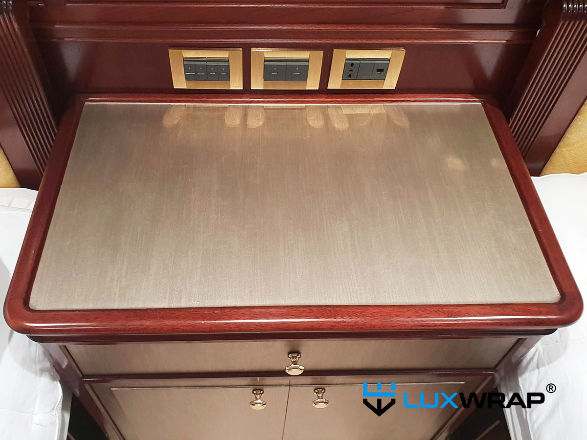 Superyacht bedside table refinished in gold architectural wrap film by LuxWrap