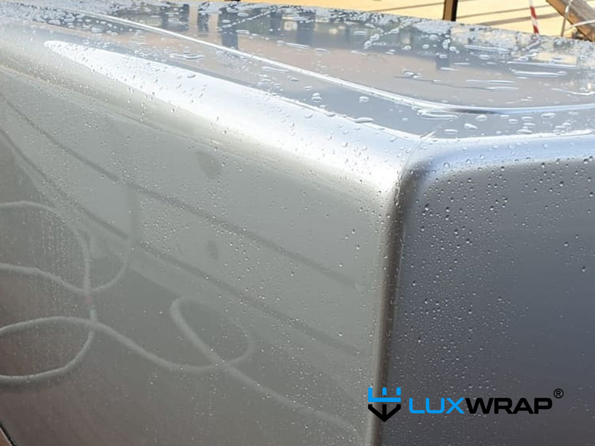 Finished NinjaShield PPF on yacht bulwark with ultra high gloss surface after squeegee application